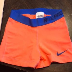 Bright orange Nike pro shorts